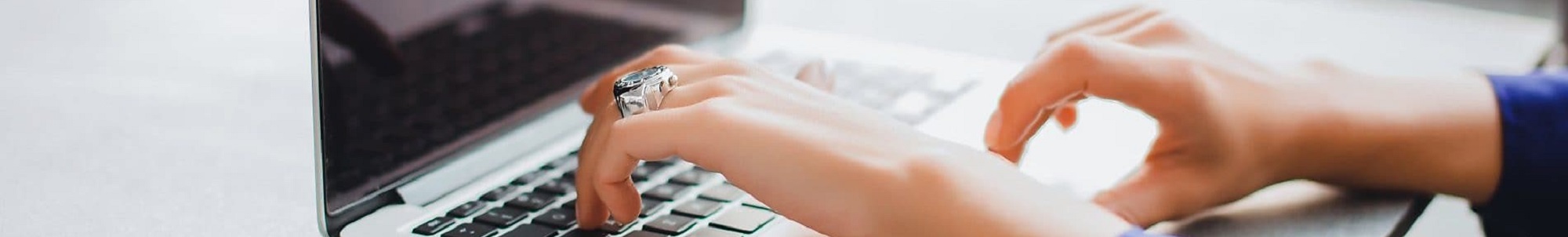 Hands at a laptop keyboard